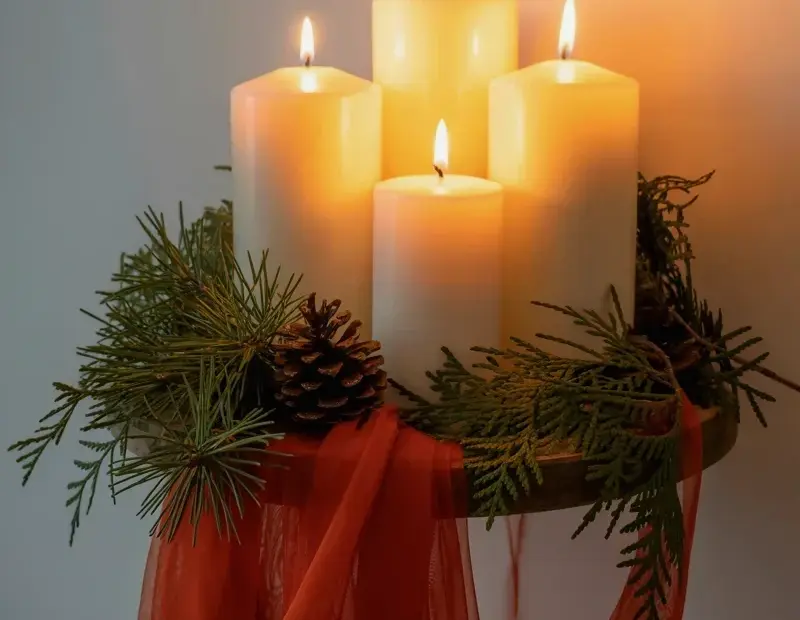Make a Cozy Winter Pillar Candle Centerpiece with Evergreen and Red Fabric